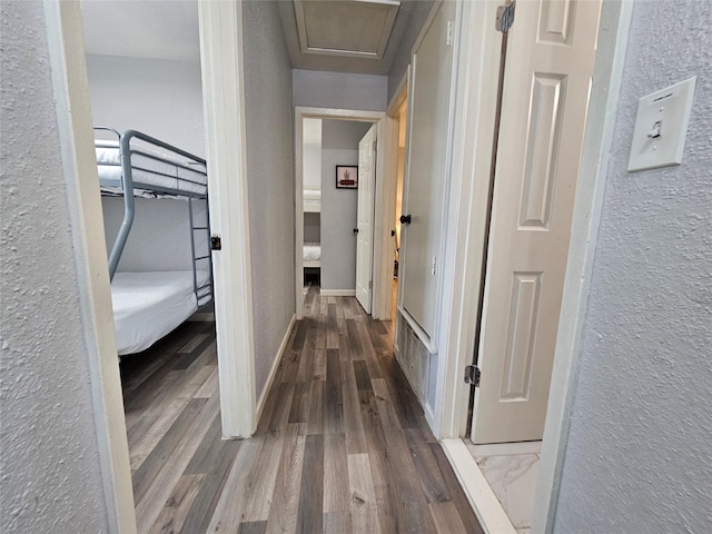 7886 Hamlet St, Houston, TX 77078 - hall with wood finished floors, a textured wall, and baseboards