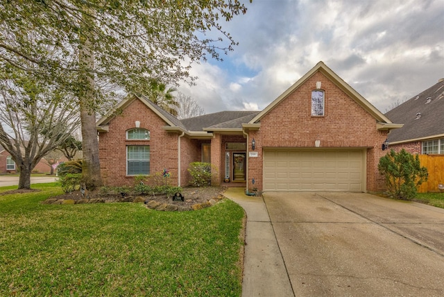 view of front property featuring a garage and a front yard