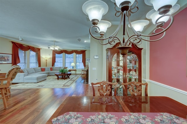 dining room featuring ceiling fan, plenty of natural light, crown molding, and hardwood / wood-style flooring