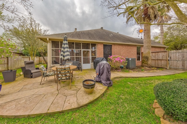 back of house with a sunroom, a patio area, and central air condition unit