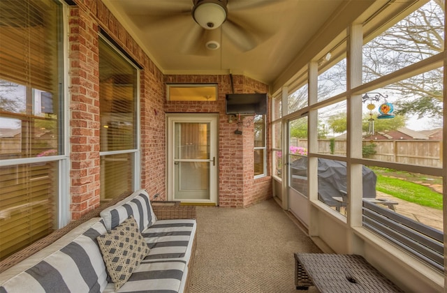 sunroom featuring ceiling fan