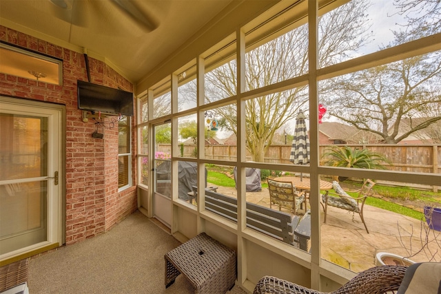 sunroom featuring lofted ceiling