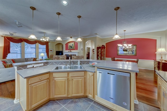 kitchen with ceiling fan with notable chandelier, sink, wood-type flooring, dishwasher, and an island with sink