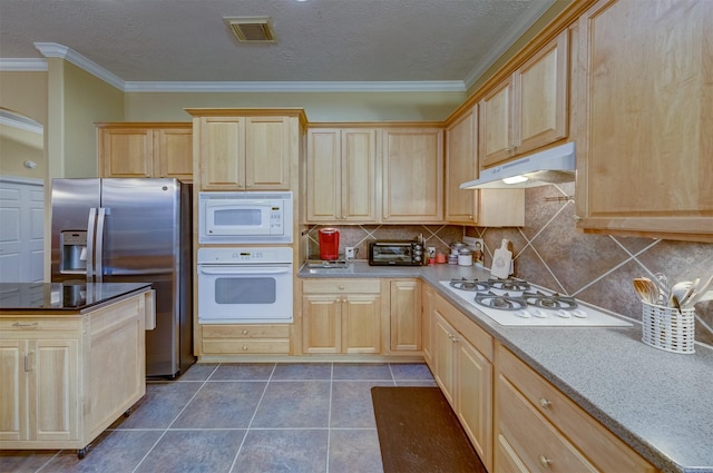 kitchen featuring light brown cabinetry, tasteful backsplash, ornamental molding, white appliances, and dark tile patterned floors