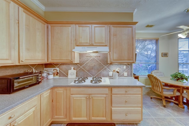 kitchen featuring ceiling fan, white gas stovetop, light brown cabinetry, light tile patterned floors, and ornamental molding