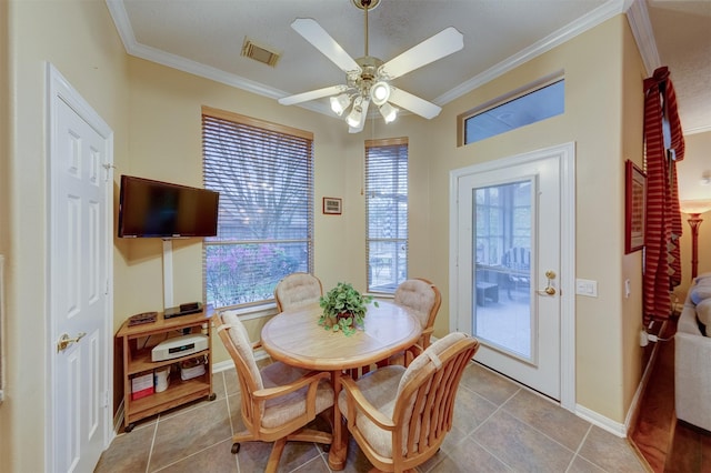 tiled dining room featuring ceiling fan and ornamental molding