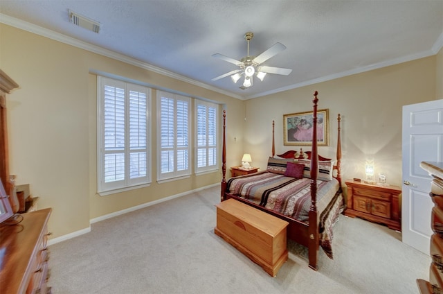 carpeted bedroom with ceiling fan and ornamental molding