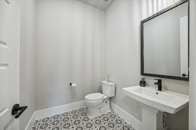 bathroom featuring tile patterned flooring and toilet