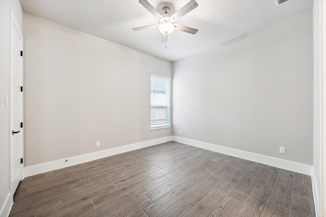 spare room with ceiling fan and dark hardwood / wood-style flooring