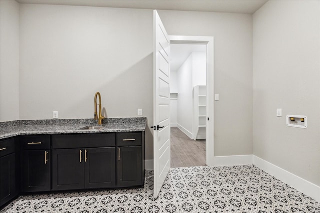 laundry room featuring cabinets, hookup for a washing machine, and sink