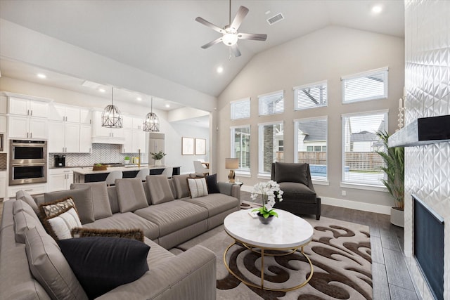 living room with ceiling fan, high vaulted ceiling, and wood-type flooring