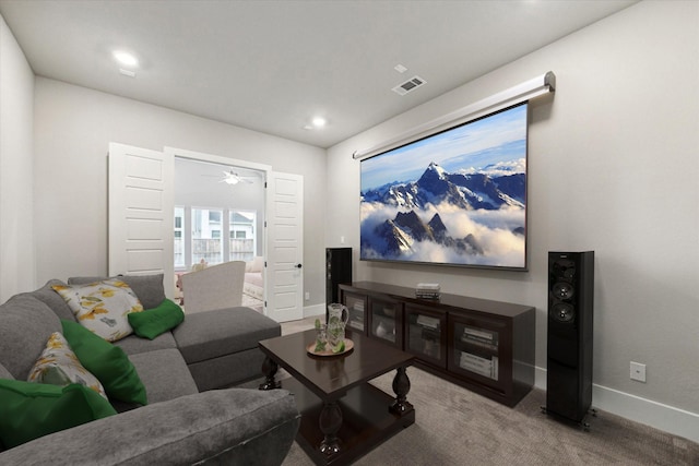 cinema room featuring carpet flooring and ceiling fan