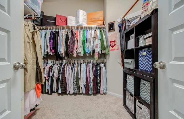 walk in closet with carpet