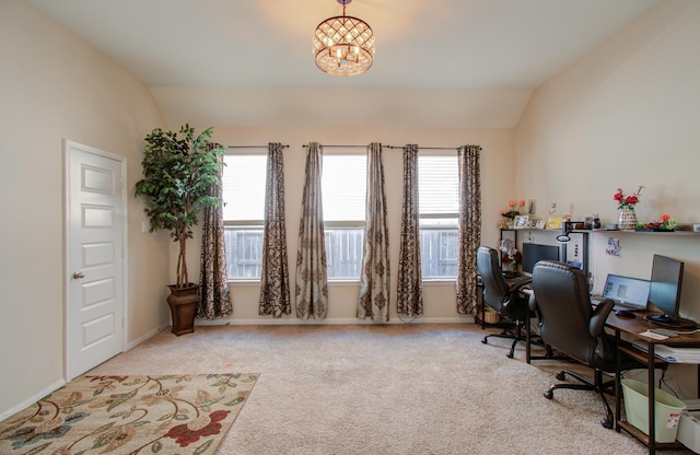 carpeted home office with a notable chandelier and lofted ceiling