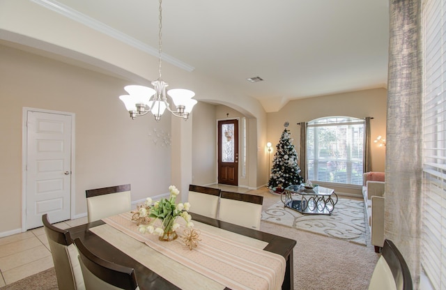 tiled dining area with an inviting chandelier and crown molding