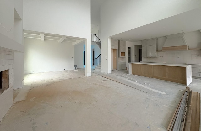 unfurnished living room with a towering ceiling