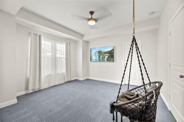 unfurnished room featuring dark carpet and ceiling fan