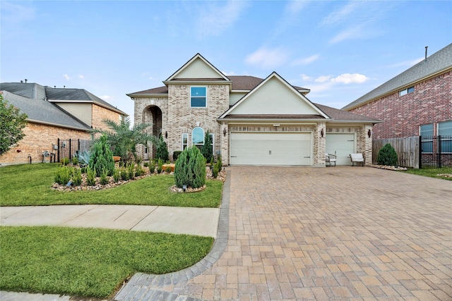 view of front of house with a front yard and a garage