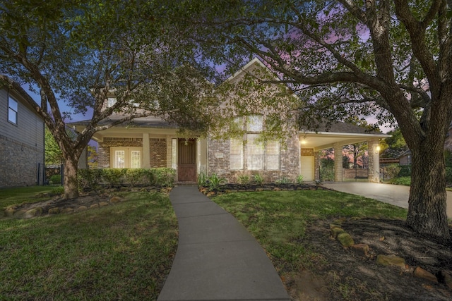 view of front facade with concrete driveway, brick siding, a front yard, and an attached carport