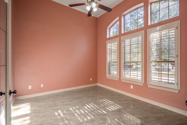 unfurnished room with a ceiling fan, baseboards, and crown molding