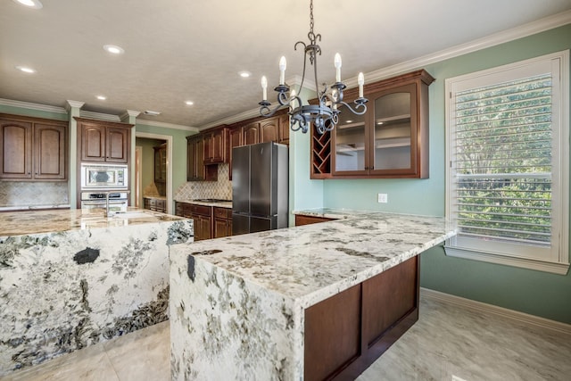 kitchen featuring stainless steel appliances, decorative backsplash, glass insert cabinets, light stone countertops, and baseboards