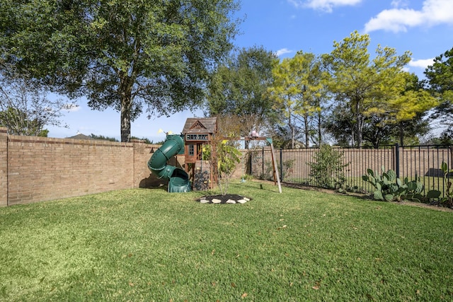 view of yard with a playground and a fenced backyard