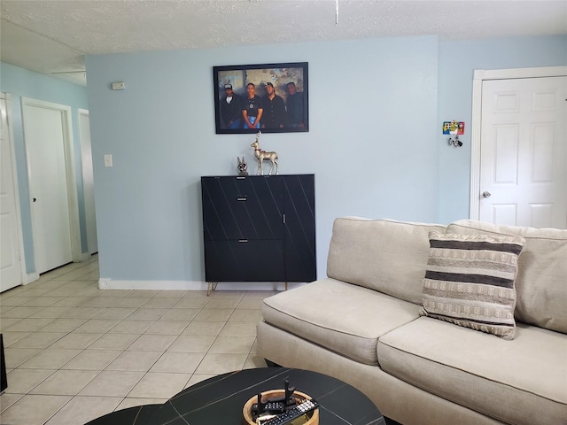 living room featuring light tile patterned flooring and a textured ceiling