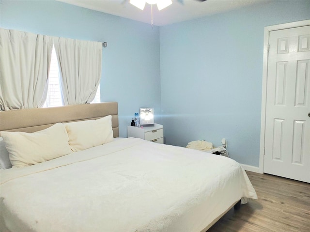 bedroom with wood-type flooring and ceiling fan