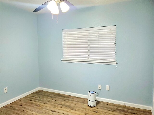 spare room featuring light hardwood / wood-style flooring and ceiling fan