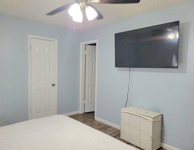 bedroom featuring hardwood / wood-style floors and ceiling fan