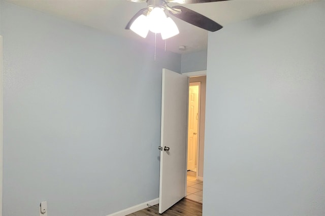 spare room with ceiling fan and light tile patterned floors