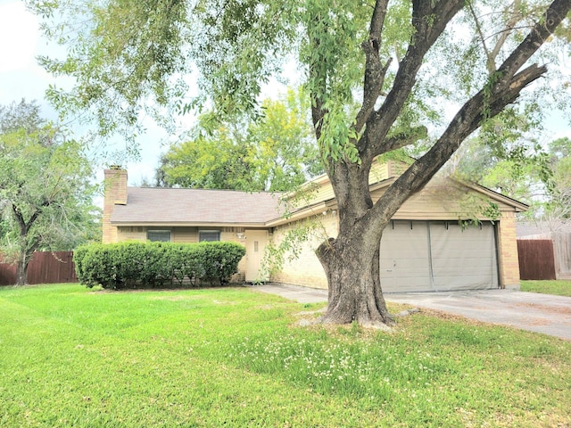 ranch-style house featuring a front yard and a garage