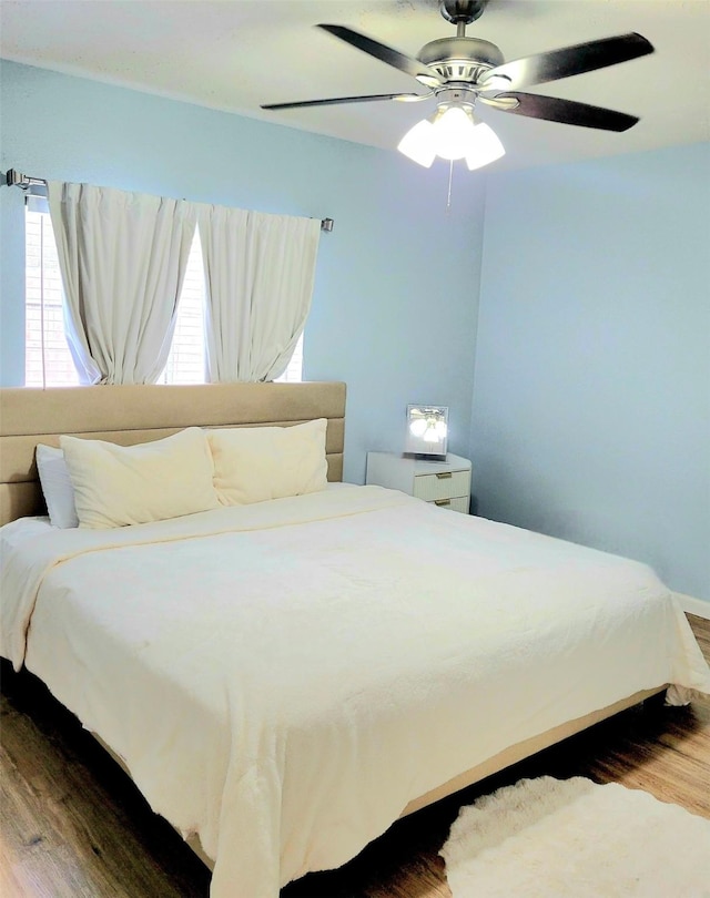 bedroom with hardwood / wood-style flooring and ceiling fan