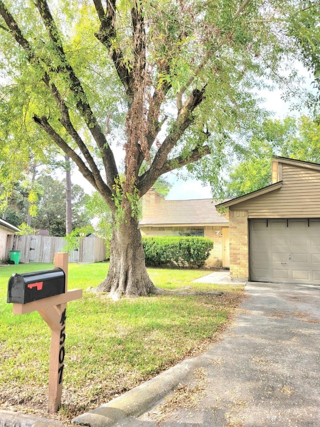 exterior space with a garage and a front lawn