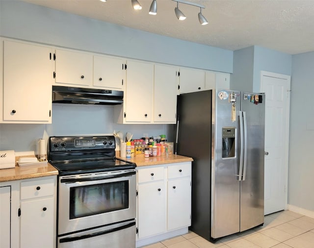 kitchen featuring appliances with stainless steel finishes, a textured ceiling, white cabinetry, and light tile patterned flooring