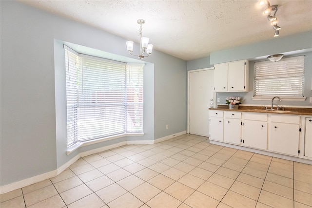4507 Adonis Dr, Spring, TX 77373 - kitchen featuring a sink, healthy amount of natural light, a chandelier, and a textured ceiling