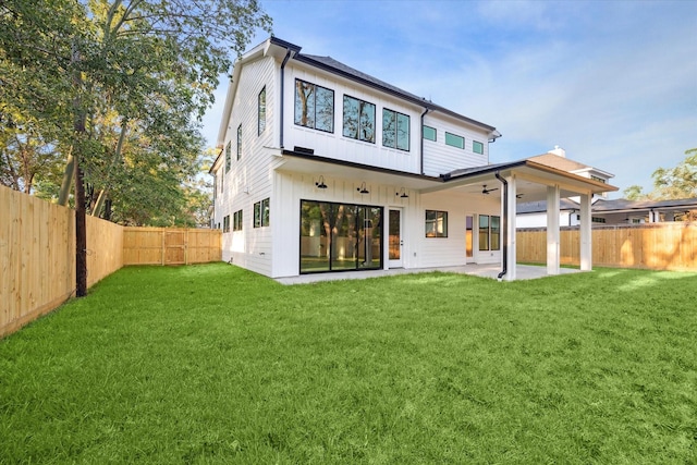 rear view of property with a yard, a patio, and ceiling fan