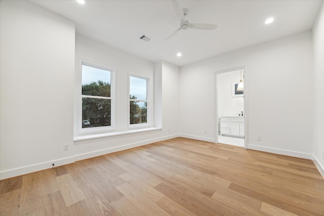 unfurnished room with ceiling fan and light wood-type flooring