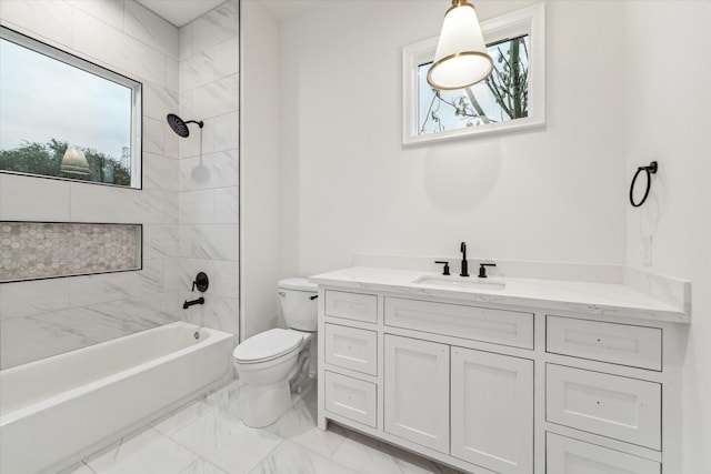 full bathroom with vanity, toilet, and tiled shower / bath