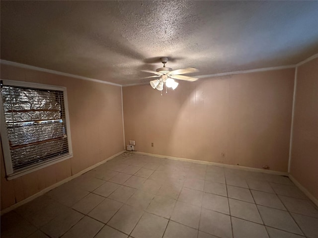 empty room featuring ceiling fan, a textured ceiling, and ornamental molding