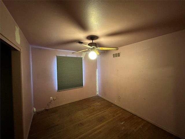 unfurnished room with dark hardwood / wood-style flooring and ceiling fan