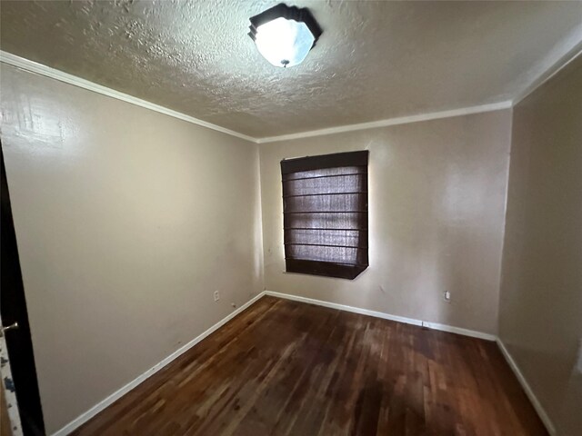 unfurnished room featuring a textured ceiling, dark hardwood / wood-style floors, and crown molding