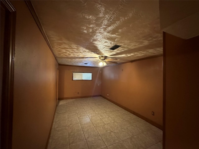 empty room featuring ceiling fan and a textured ceiling