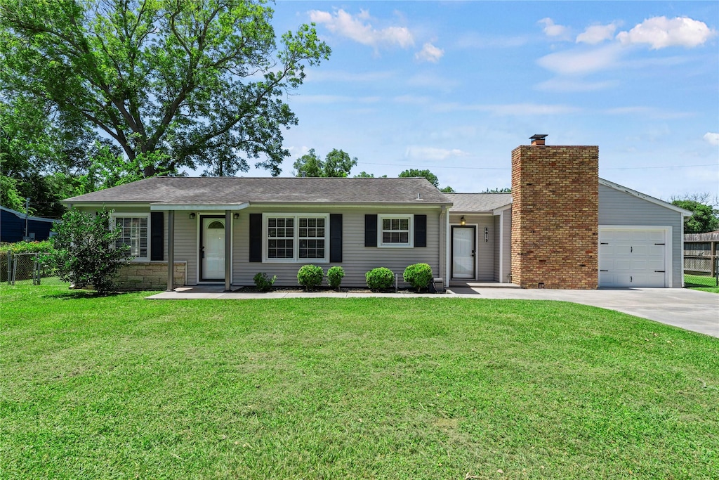 single story home with a garage and a front lawn