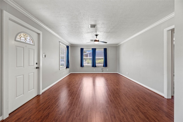 entrance foyer featuring a textured ceiling, a wealth of natural light, ceiling fan, and dark hardwood / wood-style floors