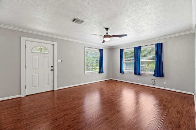 interior space with a textured ceiling, dark hardwood / wood-style flooring, ceiling fan, and crown molding