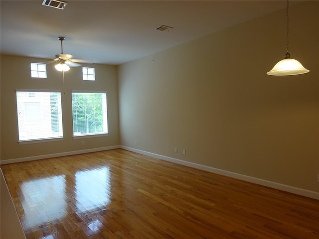 unfurnished room featuring hardwood / wood-style floors and ceiling fan