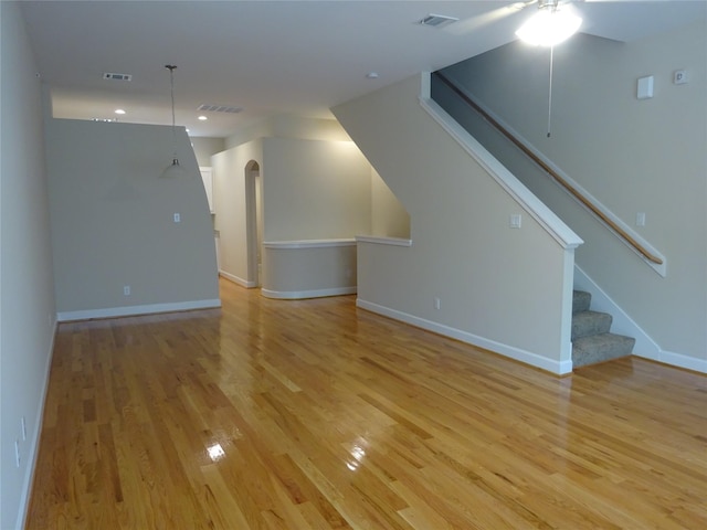 unfurnished living room featuring ceiling fan and light hardwood / wood-style floors