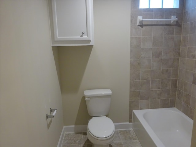 bathroom featuring tile patterned flooring, tiled shower / bath combo, and toilet