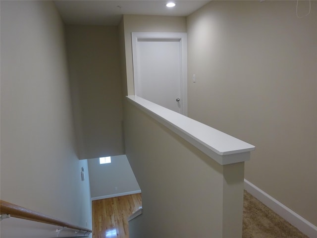 staircase with hardwood / wood-style flooring